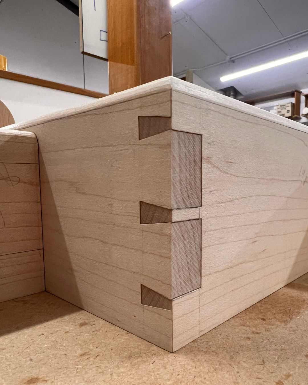 Hand-cut mitred dovetail corner for a wall cabinet