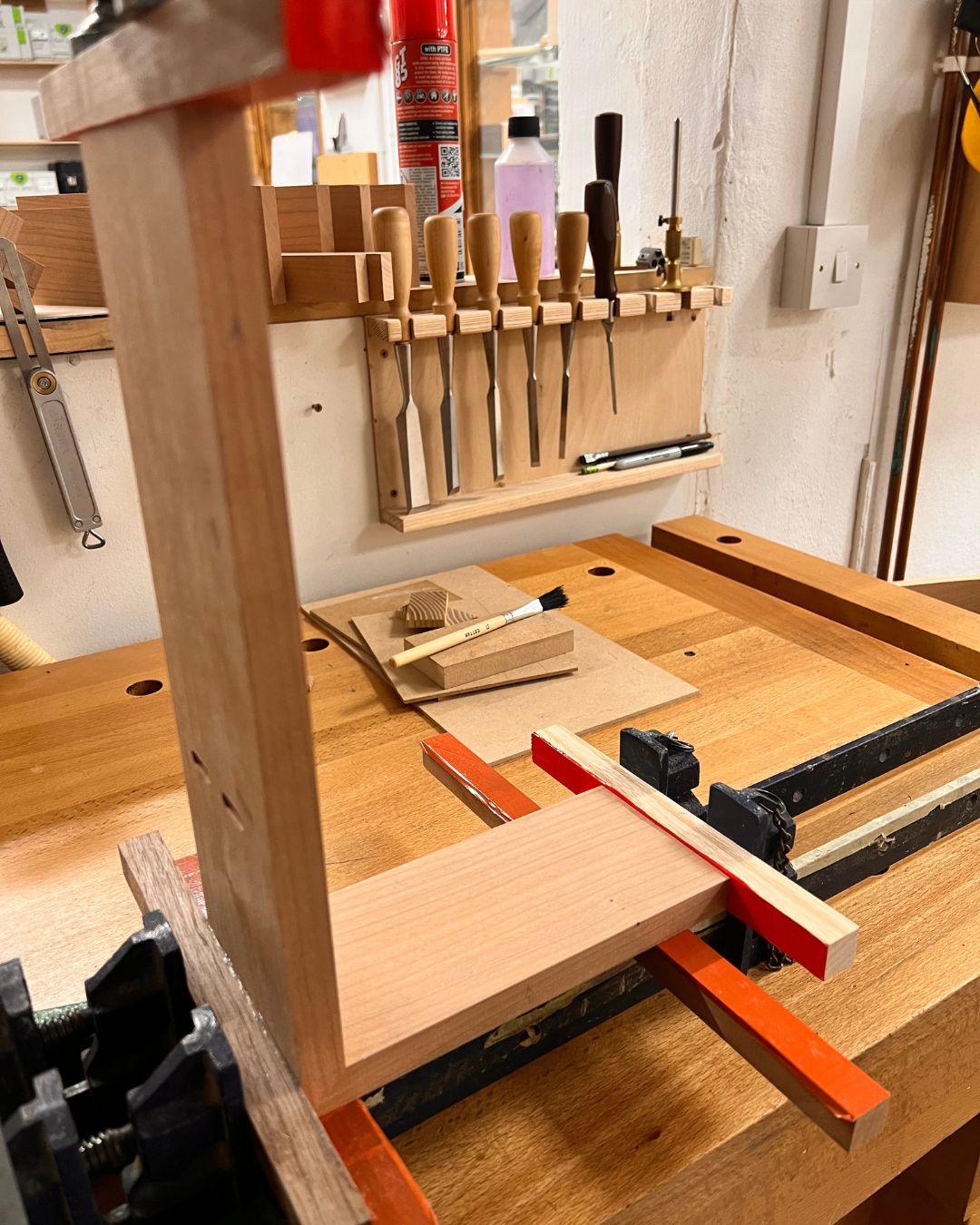 Mitred wall cabinet components being glued together